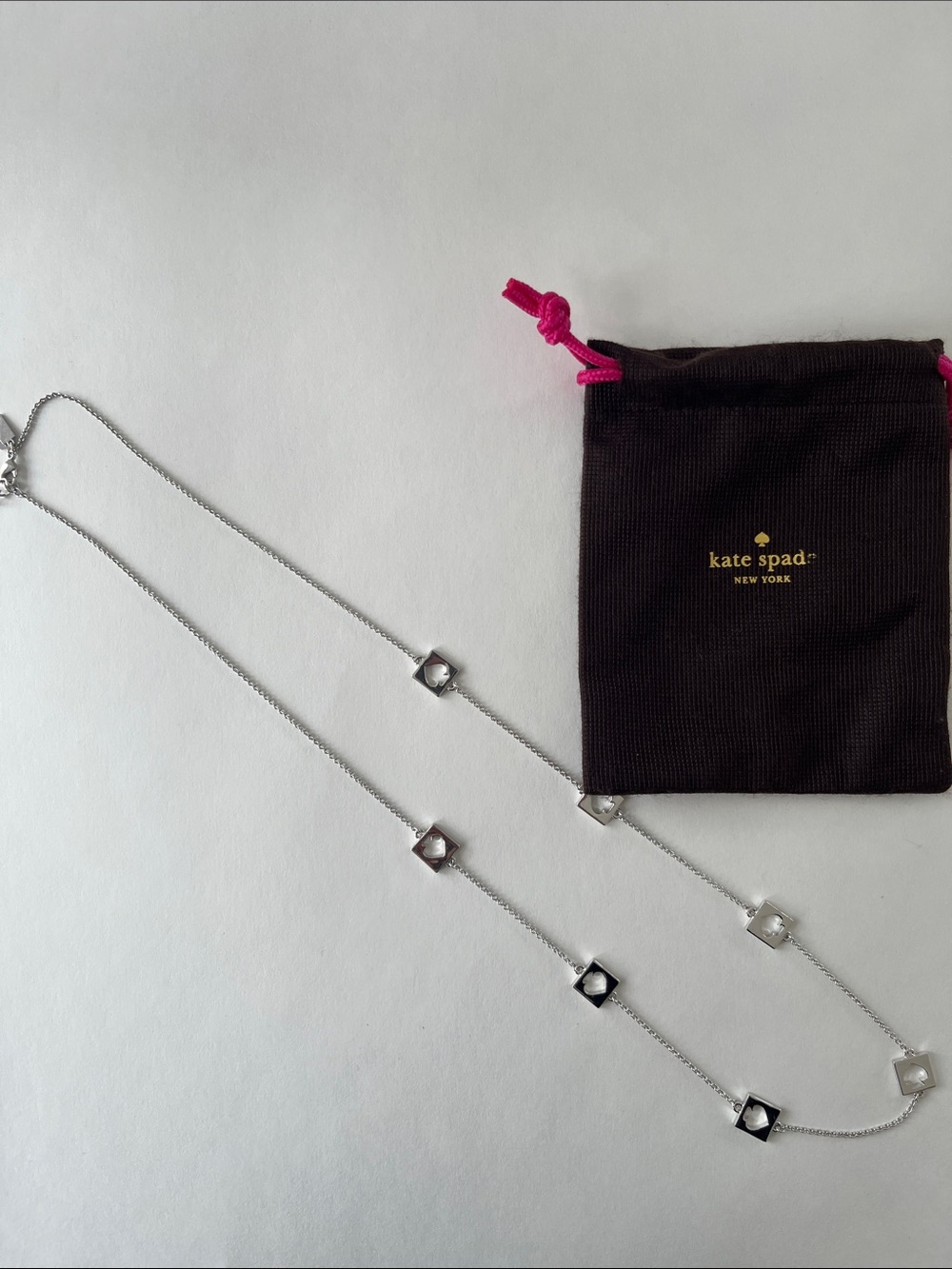 Kate Spade silver-Hole Punch Spade necklace- 30”L. Pouch included